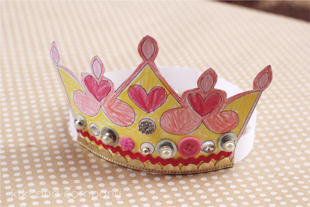 Paper crown that has been colored and has gem sitckers on it.