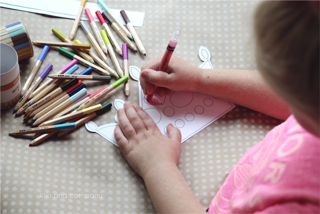 free printable crown being colored with colored pencils by a little girl.